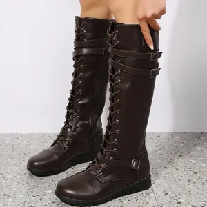 Close-up of brown lace-up knee-high knight boots with adjustable buckle straps