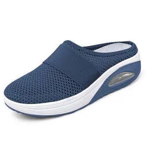 Side view of women's blue mesh slip-on mule with thick white sole and air cushion