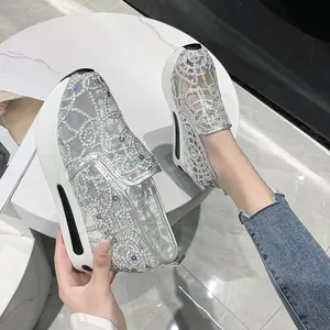 Detailed view of women's silver mesh embroidered platform sneakers with sparkling rhinestones
