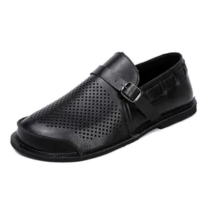 Detailed view of men's black perforated leather shoe with stylish buckle strap design