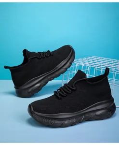 Close-up of black fly-knit sock sneakers with thick textured sole and breathable mesh