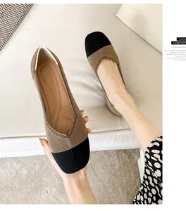 Detailed view of women's square toe woven flat shoes featuring contrast black and tan design