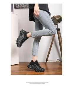 Detail of lightweight black knitted sneakers with EVA foam sole worn by a model