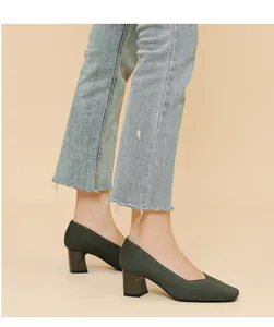 Close-up of dark green ribbed block heel pumps with square toe and V-neck design