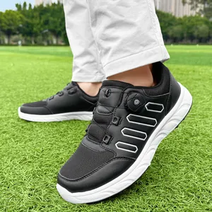 Lightweight black and white men's golf shoes with rotary buckle closure on grass.