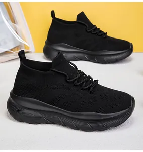 Detailed macro view of the breathable flying woven fabric on black slip-on sock sneakers.