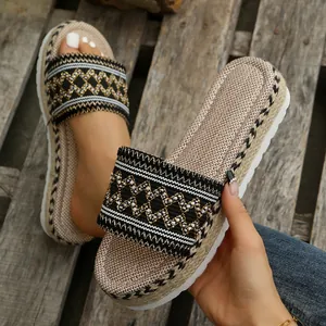 Close-up of ethnic woven pattern and jute platform detail on boho slides