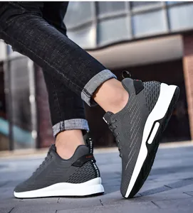 Side view of grey knit height-increasing sneakers showing the breathable texture.