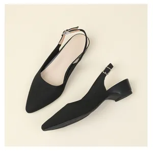 Detailed view of breathable black knitted pointed-toe slingbacks with low block heels.