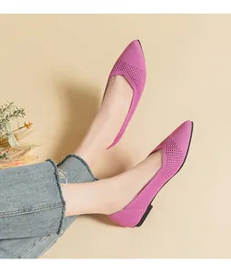 Detailed view of pink knitted pointed-toe flat shoes featuring a stylish hollow-out design