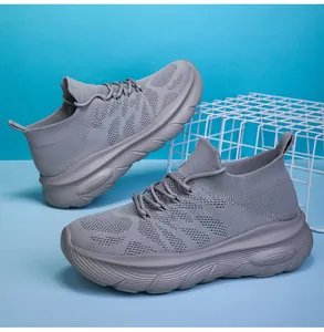 Close-up of grey breathable fly-knit mesh sneakers with thick slip-on sole design.