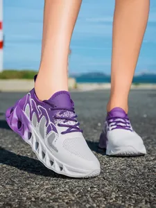 Close-up of purple and white breathable fly-knit running shoes with hollow-out sole.
