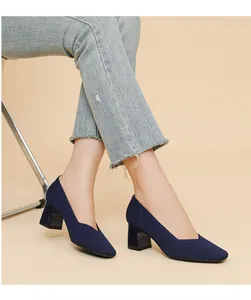Side view of elegant navy blue knitted block heel pumps with a stylish square toe