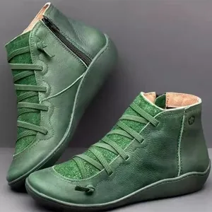 Vintage green leather flat ankle boots with cross-laced detail and side zipper