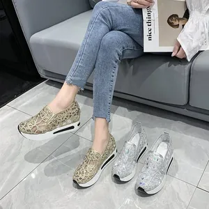 Detail view of breathable gold mesh platform sneakers with rhinestone embroidery.