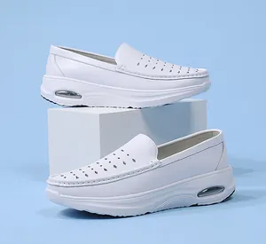Detail view of white leather nurse shoes with air cushion sole and perforated design.