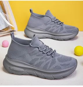 Detail of grey flyknit sock sneakers with thick anti-slip soles for men and women.