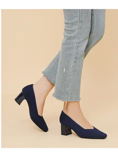 Detailed view of navy blue ribbed knit block heel pumps with square toe and V-cut design