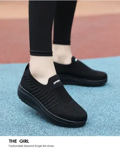 Detailed view of women's all-black slip-on walking shoes with ergonomic rocker soles