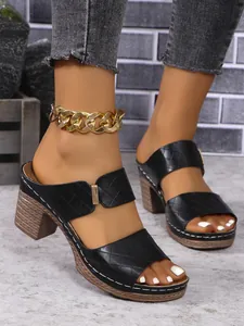 Close-up shot of women's black quilted strap sandals featuring a textured block heel