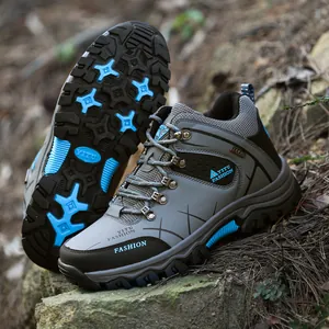 Men's high-top grey hiking boots with rugged lugged soles for outdoor trekking