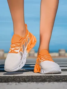 Side view of orange and white breathable flyknit running shoes with hollow sole
