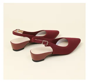 Macro detail of burgundy pointed-toe knit slingback pumps featuring low block heel