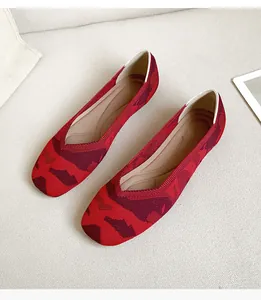 Detailed view of red knitted square-toe flat shoes with a retro leopard pattern