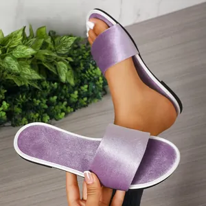 Close-up view of elegant purple velvet slide sandals featuring refined white trim