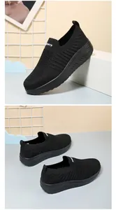 Macro view of black slip-on walking shoes featuring breathable mesh texture and thick sole