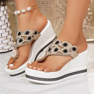 Detailed view of fashionable women's rhinestone wedge platform flip-flops with pearls