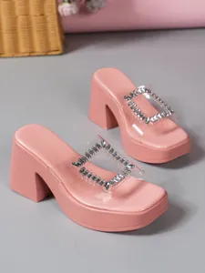 Detail showing pink platform high heel slippers with clear strap and rhinestone buckle