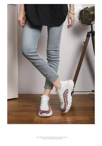 Stylish white breathable knit sneakers with colorful accents worn by an Asian model