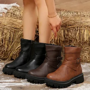 Detailed view of women's vintage Martin boots in black, dark brown, and tan colors