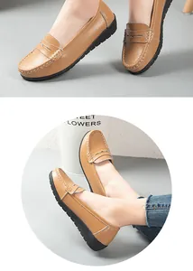 Detailed close-up view of tan leather loafers featuring white stitching and durable rubber sole