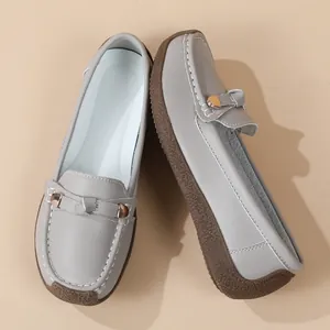 Classic grey soft faux leather loafers for women featuring decorative gold metal buckles