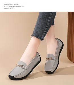 Exquisite detail of women's gray leather loafers with gold chain and soft sole