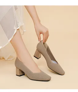 Detailed shot of elegant taupe ribbed knit block heel pumps featuring a square toe and V-cut
