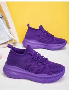 Close-up detail showing the breathable purple flyknit texture of these platform sneakers