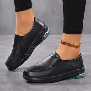 Detail view of black slip-on nurse shoes with breathable cut-outs and air cushion sole.