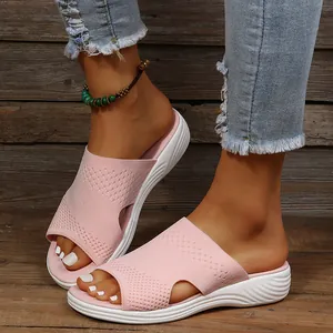 Close-up of pink knitted summer slippers for women featuring a comfortable white sole.