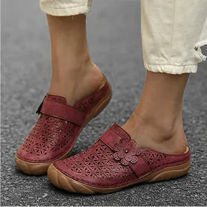Detailed close-up of burgundy clogs featuring laser-cut floral patterns and 3D accents.