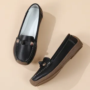 Detailed side view of black leather loafers with a soft textured anti-slip rubber sole