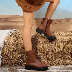 Close-up of vintage brown motorcycle boots with chunky black soles in desert setting