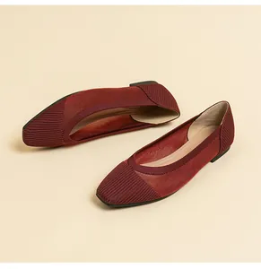 Close-up of breathable burgundy mesh knit flat shoes with elegant square toe design.