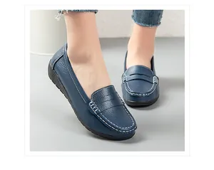 Detailed side view of blue leather loafers featuring white contrast stitching and flat rubber sole