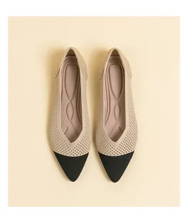 Detailed macro view of beige and black pointed-toe breathable knit flats for women.