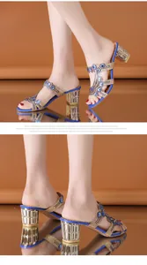 Detailed view of elegant blue rhinestone chunky heel sandals featuring intricate crystal decor.