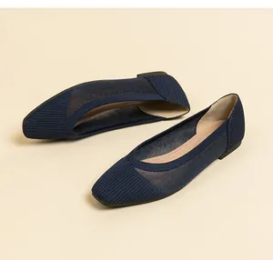Close-up detail showing the mesh woven texture and square toe of navy flat shoes