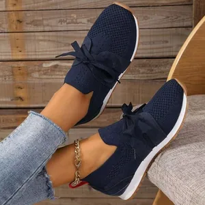 Stylish women's navy blue fly-woven mesh sneakers featuring an elegant bow lace-up design